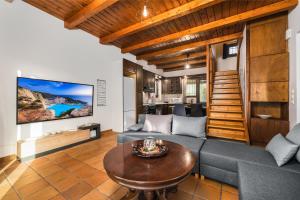 a living room with a couch and a table at The House of Love in Tragaki