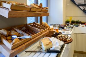 a table topped with lots of different types of bread at Four Points Express by Sheraton Istanbul Taksim Square in Istanbul