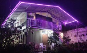 a house with purple lights on it at night at Townside Lodge in Nuwara Eliya