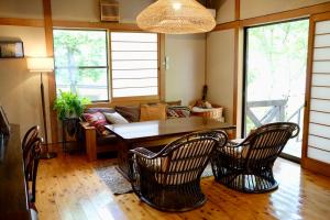 a living room with a table and chairs and a couch at 'Imi Ola House in Yufuin