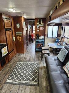an rv living room with a couch and a table at Rv adventure Roscoe Pet friendly in Roscoe