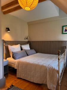 a bedroom with a large bed with blue pillows at Grosse Perle in Brodersby OT Schönhagen