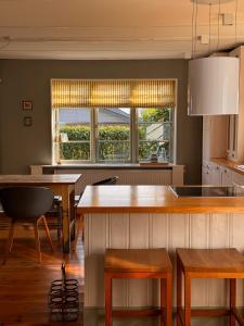 a kitchen with a island with a table and chairs at Grosse Perle in Brodersby OT Schönhagen