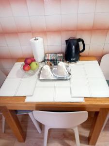 a table with a tea kettle and fruit on it at Old town Jelena loft Room in Dubrovnik