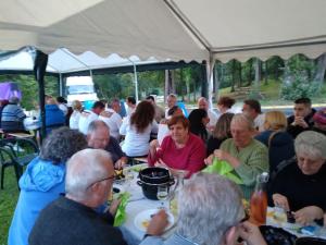 a group of people sitting at tables under a tent at Camping Hurongues in Pomeys