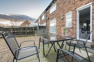 a group of chairs and a table on a patio at Large 3 bedroom Liverpool Free parking in Liverpool