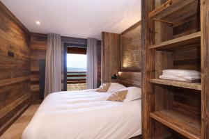 a bedroom with a large bed with wooden walls at Résidence l'Insolite in Font Romeu Odeillo Via