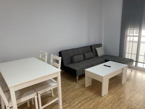 a living room with a couch and two tables at BALERMAPLAYA calle lago in Balerma