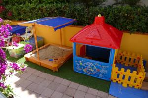 a toy house and a play house with a sandbox at Villa Toscana in Zaboric