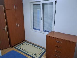 an empty room with a dresser and a window at Dama 1 in Bitola