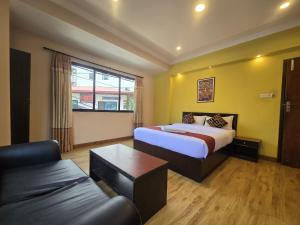 a hotel room with a bed and a couch at Cascade Hotel in Kathmandu