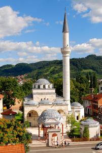 a mosque with a tall tower in a city at Apartman MRL Cavic in Banja Luka