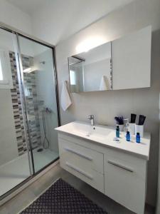 a bathroom with a white sink and a shower at Beachfront Villa Gia Paros in Kampos Paros +77 photos