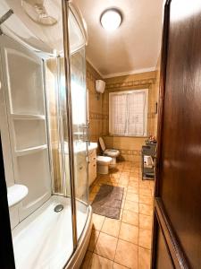 a bathroom with a shower and a toilet and a sink at Villa Iris Suvera Chianti in Ponte A Bozzone