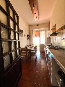 a kitchen with a table and a dining room at Villa Iris Suvera Chianti in Ponte A Bozzone +12 photos