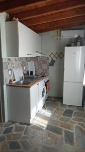 a kitchen with a sink and a stove and a refrigerator at Anna’s Olive Grove in Ammouliani