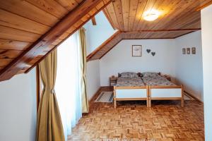 a bedroom with a bed and a large window at Cozy family place 'Hiša Grozdek' - Gruškovec 40A in Gruškovec