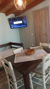 a dining room table with a bowl on top of it at Anna’s Olive Grove in Ammouliani