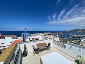 a balcony with a view of a marina at SUNNY DAY Deluxe 1 in La Playa de Arguineguín