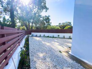 a backyard with a fence and a tree at Protaras Sunny Villa in Protaras