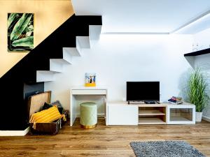 a living room with a staircase and a television at Laura apartment in Budapest