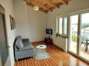 a living room with a chair and a table at Apartment Tulip in Premantura