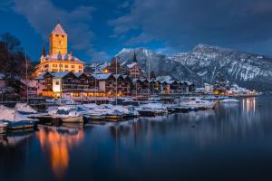 a marina with boats in the water at night at Hotel-Restaurant Seegarten-Marina in Spiez