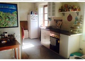 Una cocina con un refrigerador blanco y una estufa. en Basoan etxea, en Sopuerta