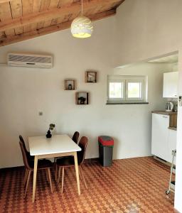 a kitchen and dining room with a table and chairs at Apartment Tulip in Premantura