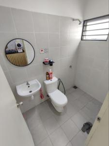a bathroom with a sink and a toilet and a mirror at Homestay Banting Selangor in Banting