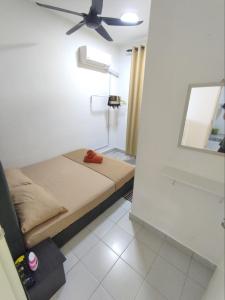 a bedroom with a bed with a ceiling fan at Homestay Banting Selangor in Banting