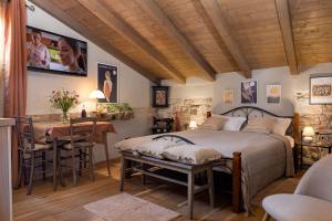 a bedroom with a bed and a table and chairs at Casa Kaligari history in Rovinj