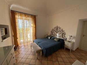 a bedroom with a bed and a table and a tv at Chez Marie Ischia in Forio d'Ischia