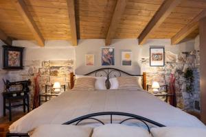 a bedroom with a large bed in a stone wall at Casa Kaligari history in Rovinj