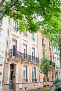 a building with balconies on the side of it at Villa Vichéia - Appartement 23 in Vichy