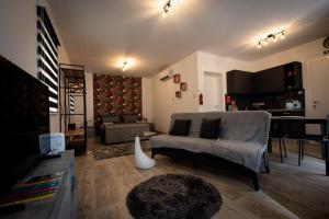 a living room with a couch and a table at Dar Barbara- Studio Apartments with Roof terrace in Cospicua