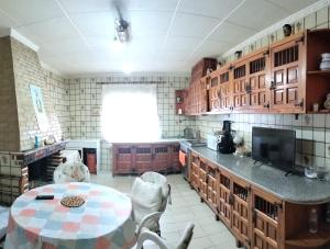 a kitchen with a table and chairs in a room at Villa Nathaly in Letur