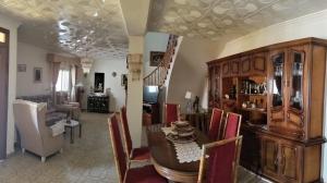 a dining room and living room with a table and chairs at Villa Nathaly in Letur