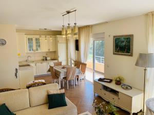 a living room with a kitchen and a dining room at Villa Vega in Kruče