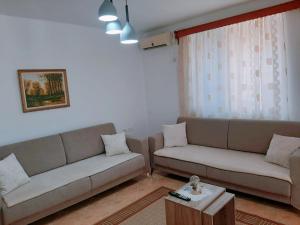 a living room with two couches and a coffee table at Vangert Apartment in Berat