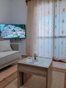 a living room with a couch and a tv at Vangert Apartment in Berat