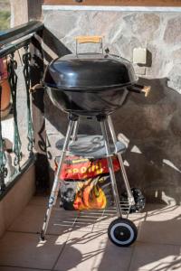 a grill sitting on a stand on a porch at Dimitra's Apartment in Mákri
