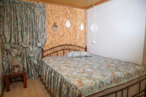 a bedroom with a bed and a curtain and a table at Dimitra's Apartment in Makri