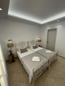 a bedroom with a large bed with two towels on it at Mare Monte Studios Naxos in Plaka