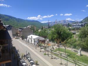 a street in a town with a mountain in the background at Apartamentos Casa Roldan I in Benasque