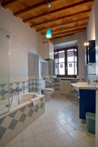 a bathroom with a tub and a toilet and a sink at Casa del Sensale in Lucca