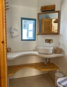 a bathroom with a sink and a mirror at BLUE IN NAXOS in Naxos Chora