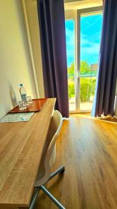 a table with two chairs and a window in a room at Apartment number 2 in Oberschleißheim