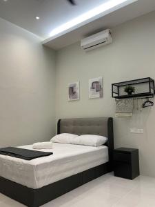 a bedroom with a bed and a air conditioner at Anjung Barakah Chalet in Kuala Terengganu
