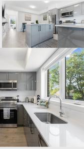 cocina con armarios grises, fregadero y ventana en Luxury Suite 4mins To Falls, en Niagara Falls